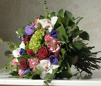 Valentines arrangement made of cymbidium orchids, roses, hortensia, tulips, alstroemeria, vanda, etc